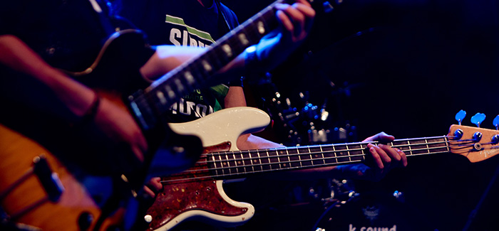a close up of two guitars being played on stage