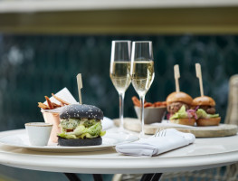 two glasses of champagne and burger meals 