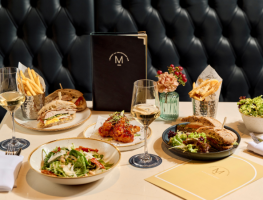 A range of small plates including a mixed leaf salad, chicken club sandwich, smoked salmon sandwich,