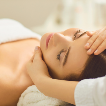 female client at the midland receiving a scalp massage relaxing