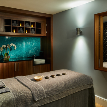 the midland rena spa treatment room with stones on the bed and r