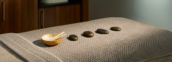 treatment bed with stones arranged on it at the rena spa at the 