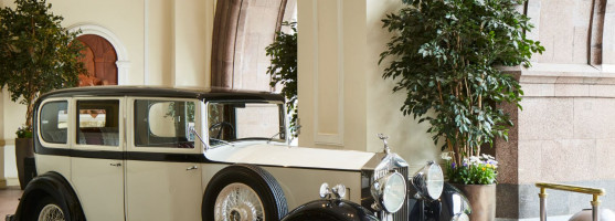 The Midland Hotel exterior and white antique car 