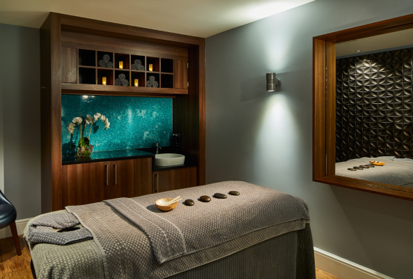 treatment room with stone on the bed at the midland rena spa